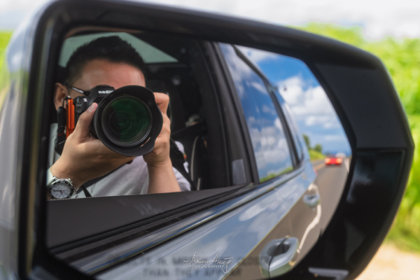 Self portrait into the side view mirror